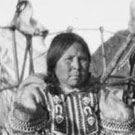 Photograph of two Inuit women and children with photographer William H. Grant on-board a ship, unknown location, Nunavut, 1922