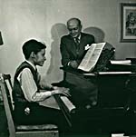 Photograph of Glenn Gould playing the piano, with his teacher Alberto Guerrero standing by, c. 1945