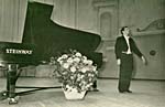 Photograph of Glenn Gould, taking a bow on stage in Russia, May 1957