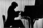 Photograph of Glenn Gould, in silhouette, playing the piano, 1957