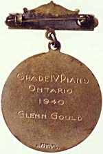Back of the Toronto Conservatory of Music silver medal, with inscription that reads GRADE IV PIANO, ONTARIO, 1940, GLENN GOULD